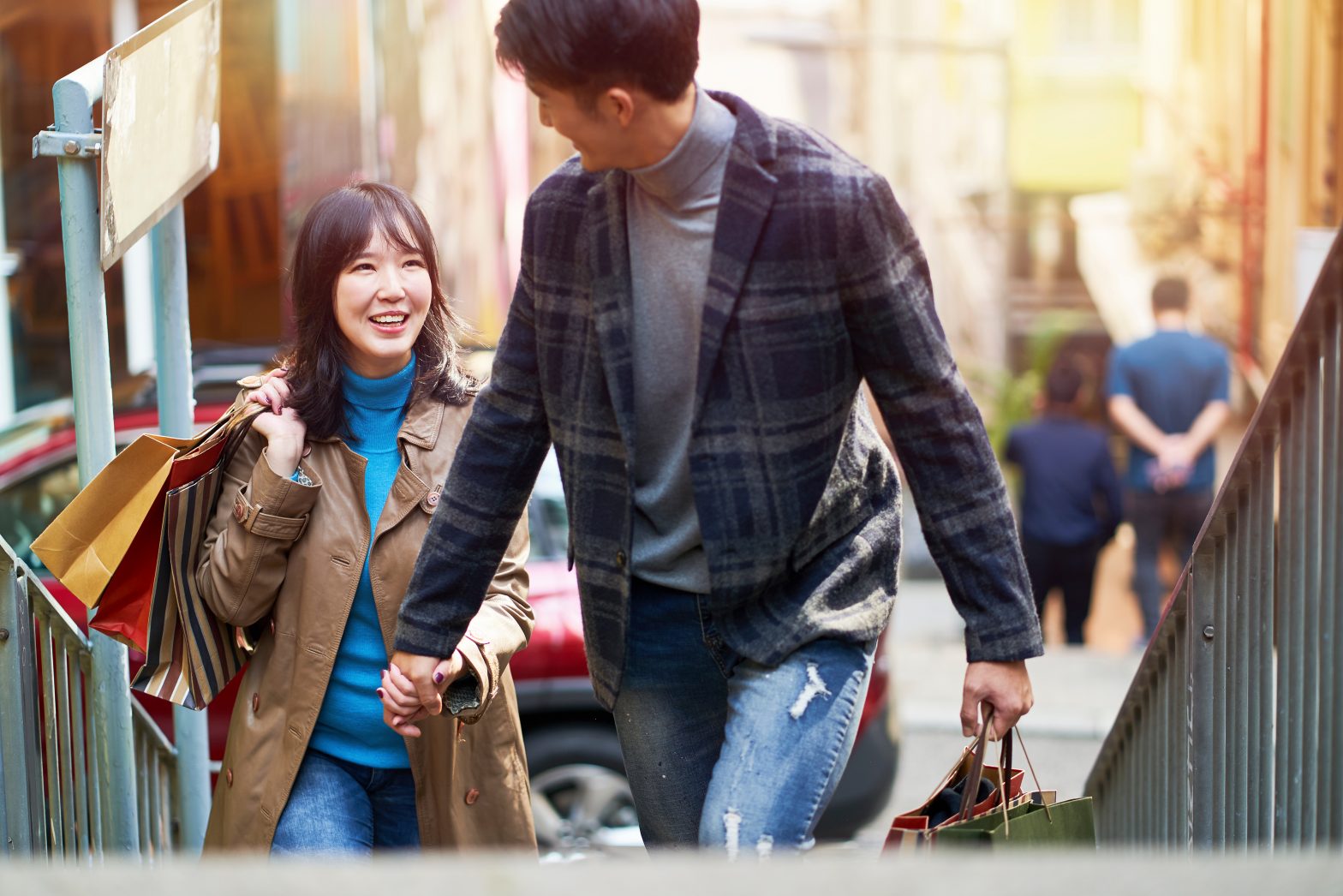 happy young asian couple shopping in the city