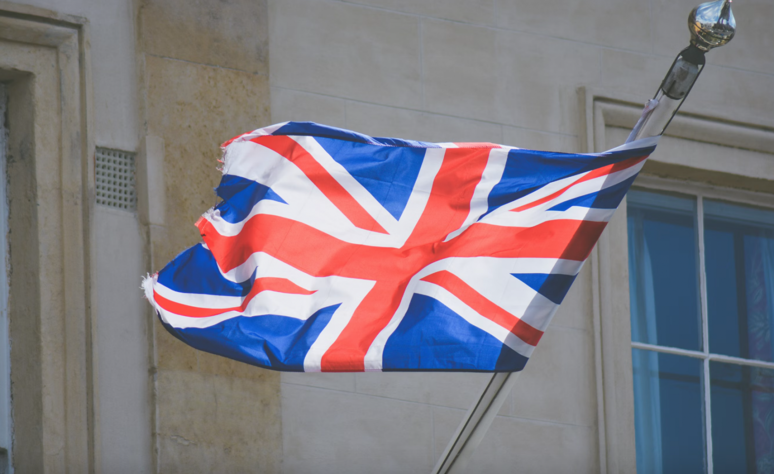A UK flag represents immigration and nationality fees set to increase in October 2023