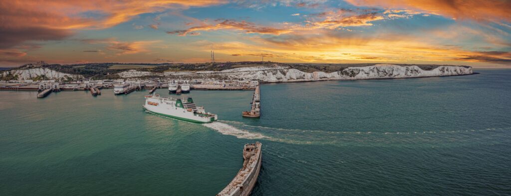 Aerial view of the Dover harbour with many ferries and cruise ships entering and exiting Dover, UK.