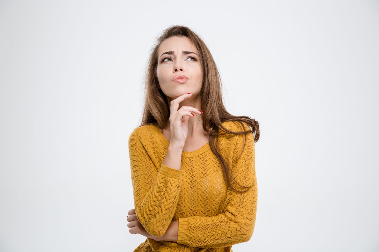 Portrait of a pensive woman standing isolated on a white background