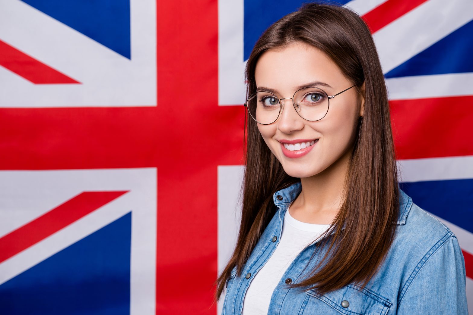 Close up photo of positive smart confident high school girl enjoy study abroad in international scholar, courses lectures wear good look clothes isolated over british flag background
