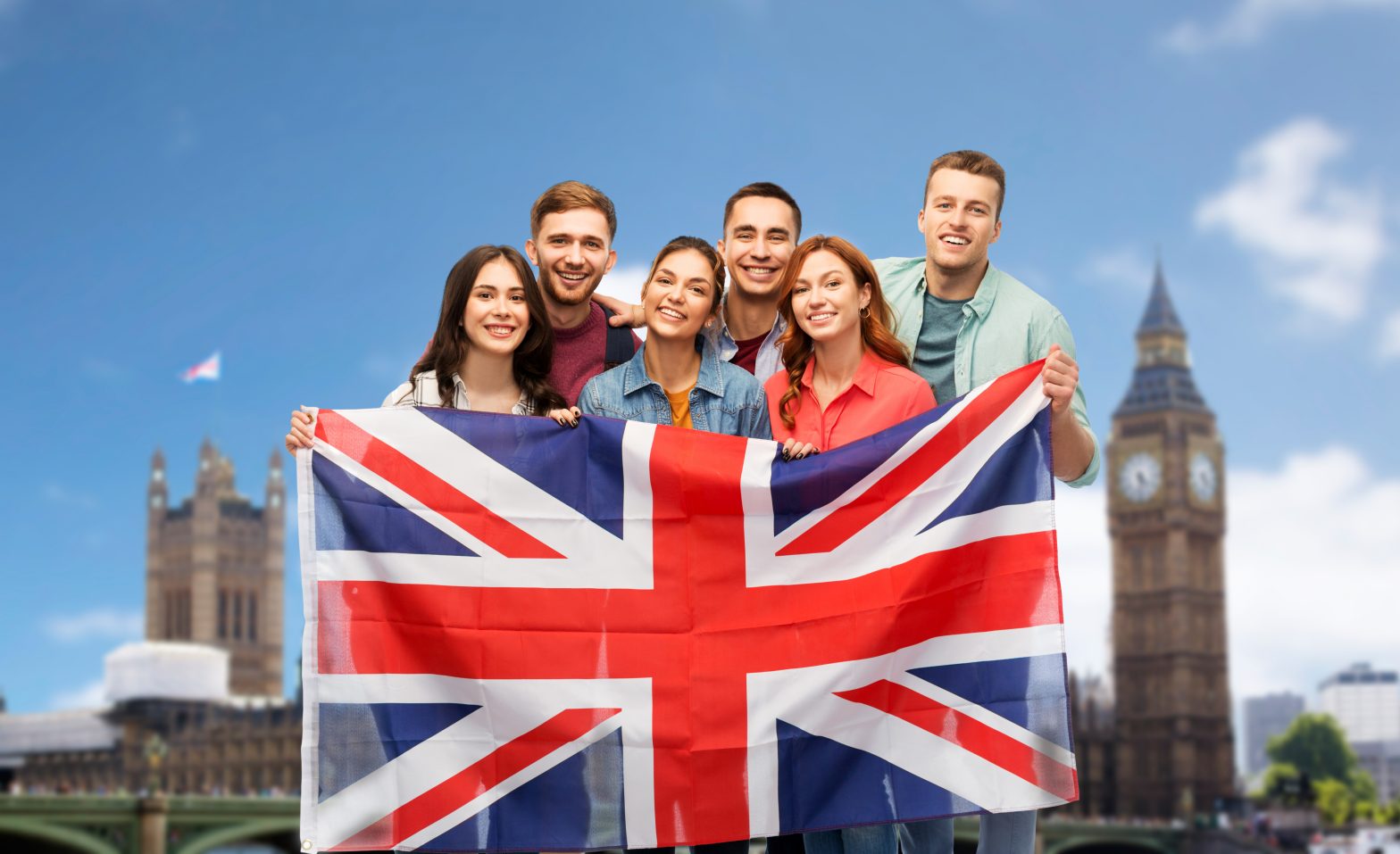group of friends with british flag over big ben