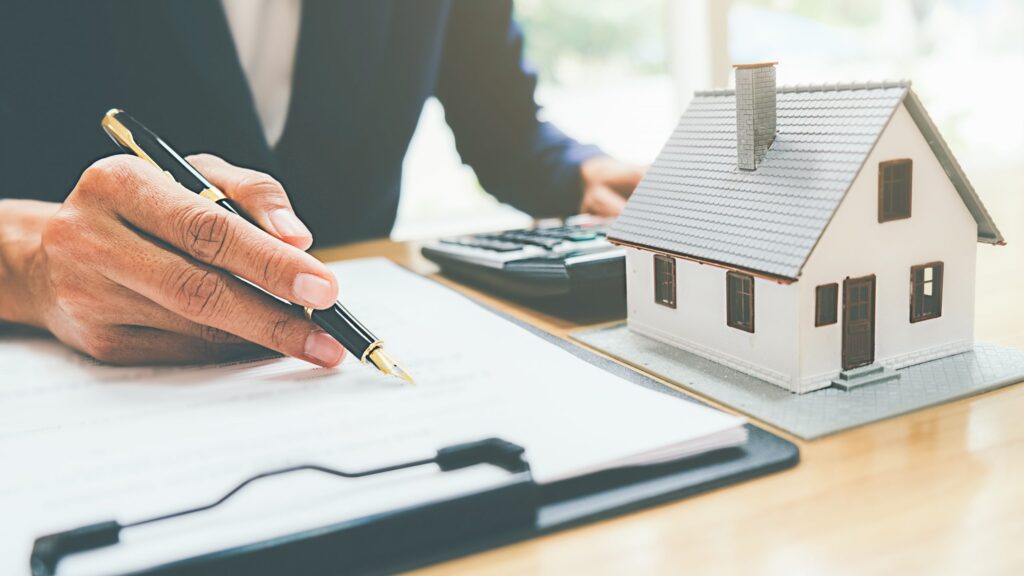 House model with real estate agent and customer discussing for contract to buy house, insurance or loan real estate background.