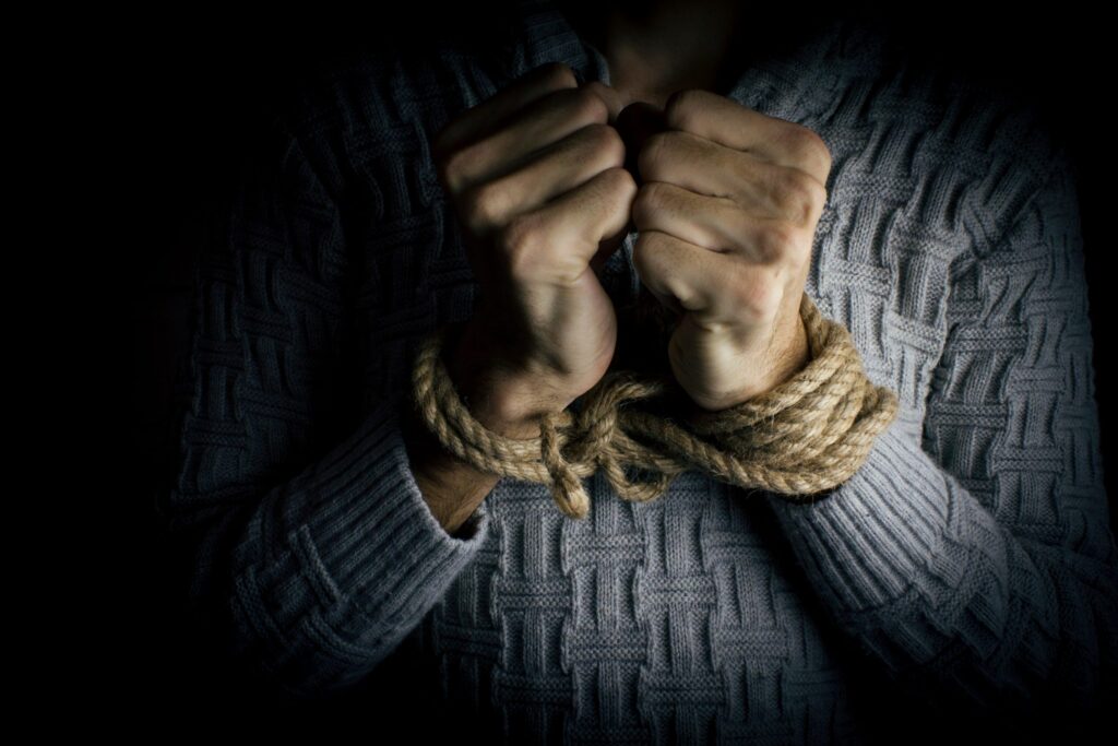 a young man tied hands