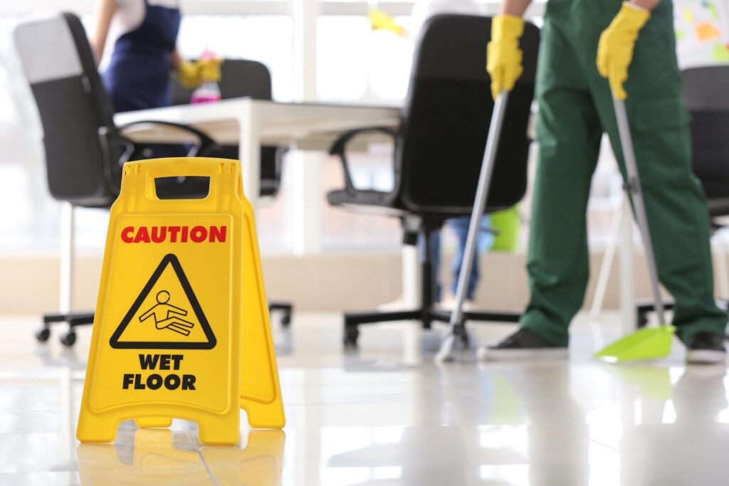 Sign board on floor in office during cleaning