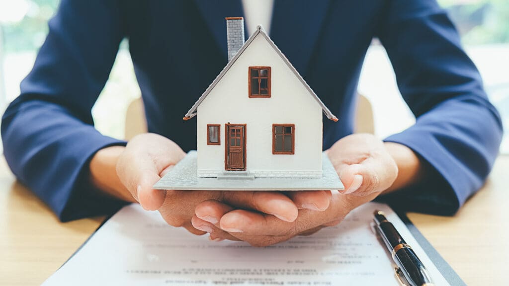 House model with real estate agent and customer discussing for contract to buy house insurance or loan real estate background
