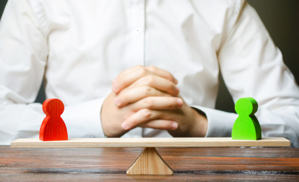 A man with hands in the lock and looks at the scales with green and red figures conflict resolution and search for a compromise Disagreement and misunderstanding establishing contact Agreements