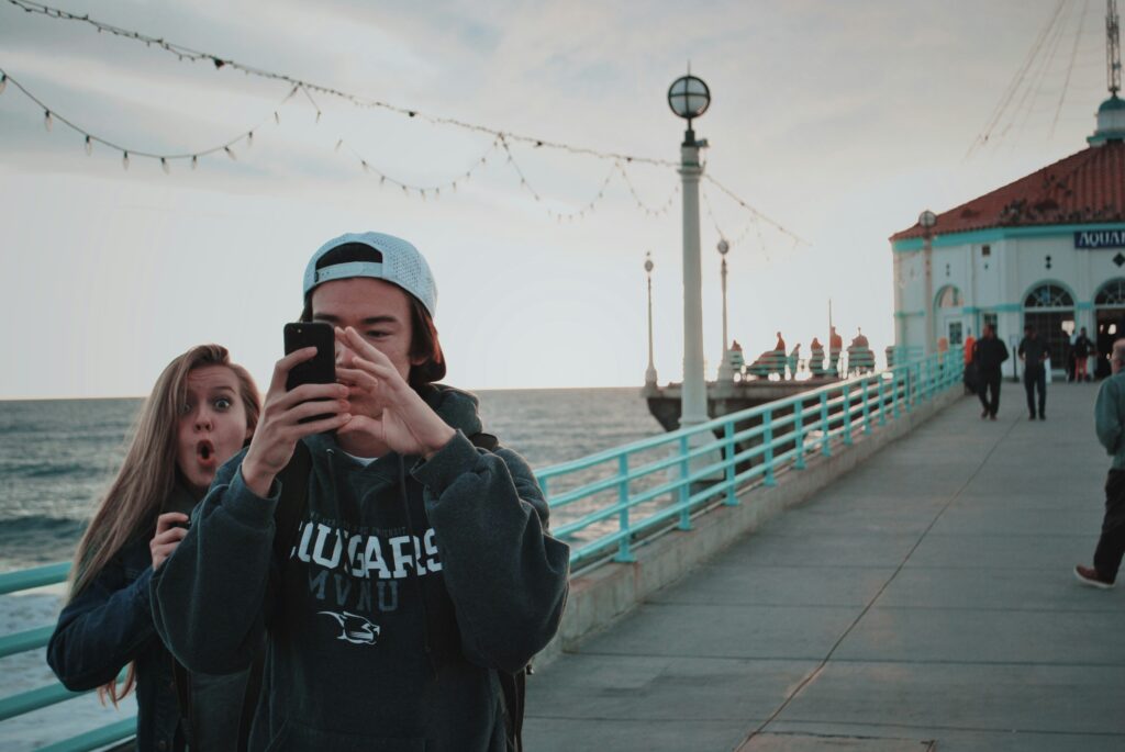 Person videoing with phone in public
