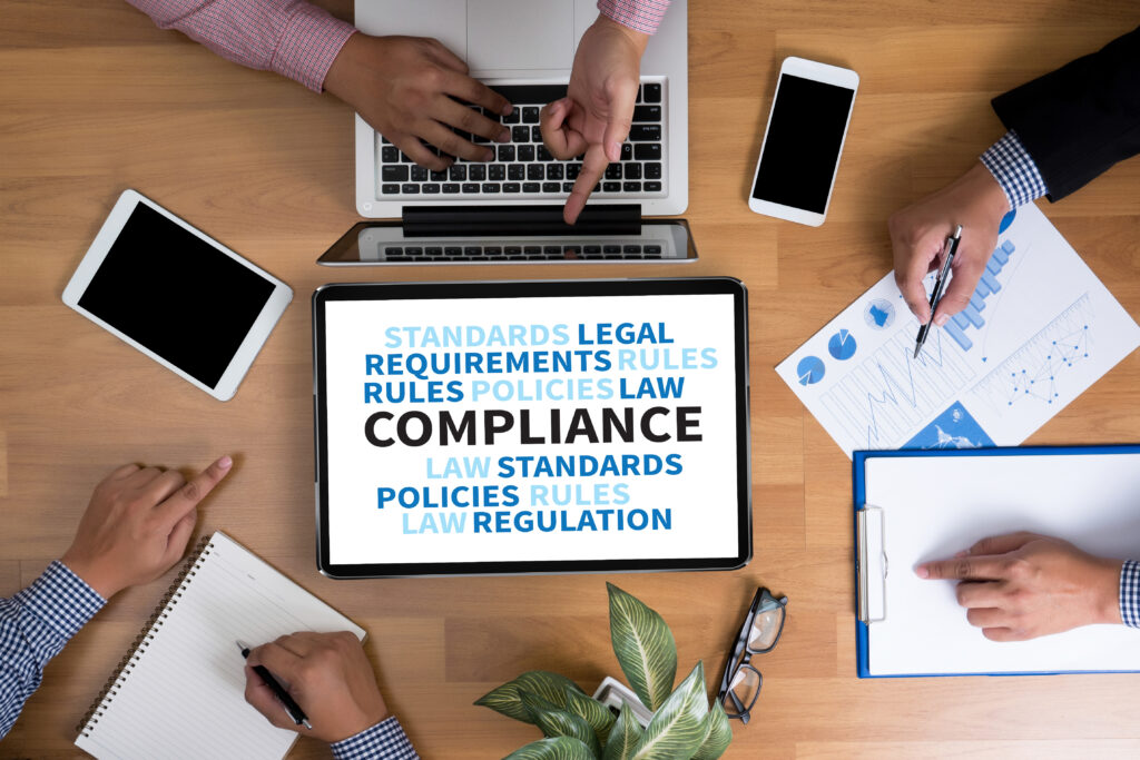 Compliance in big font surrounded by images related to regulation