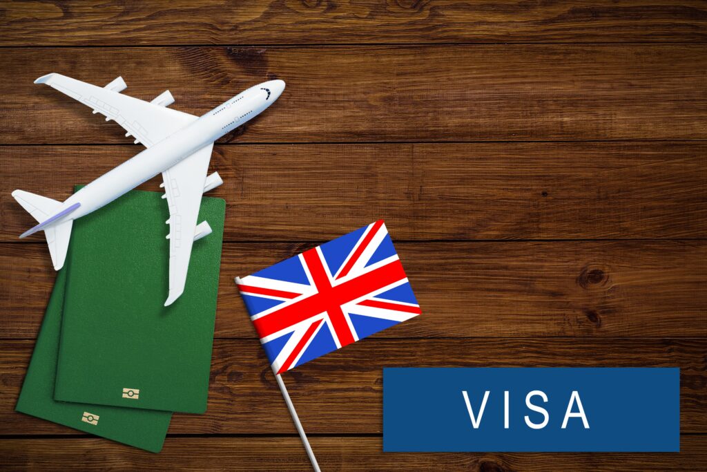 graphic of small plane flying over wooden background with british flag and the word visa