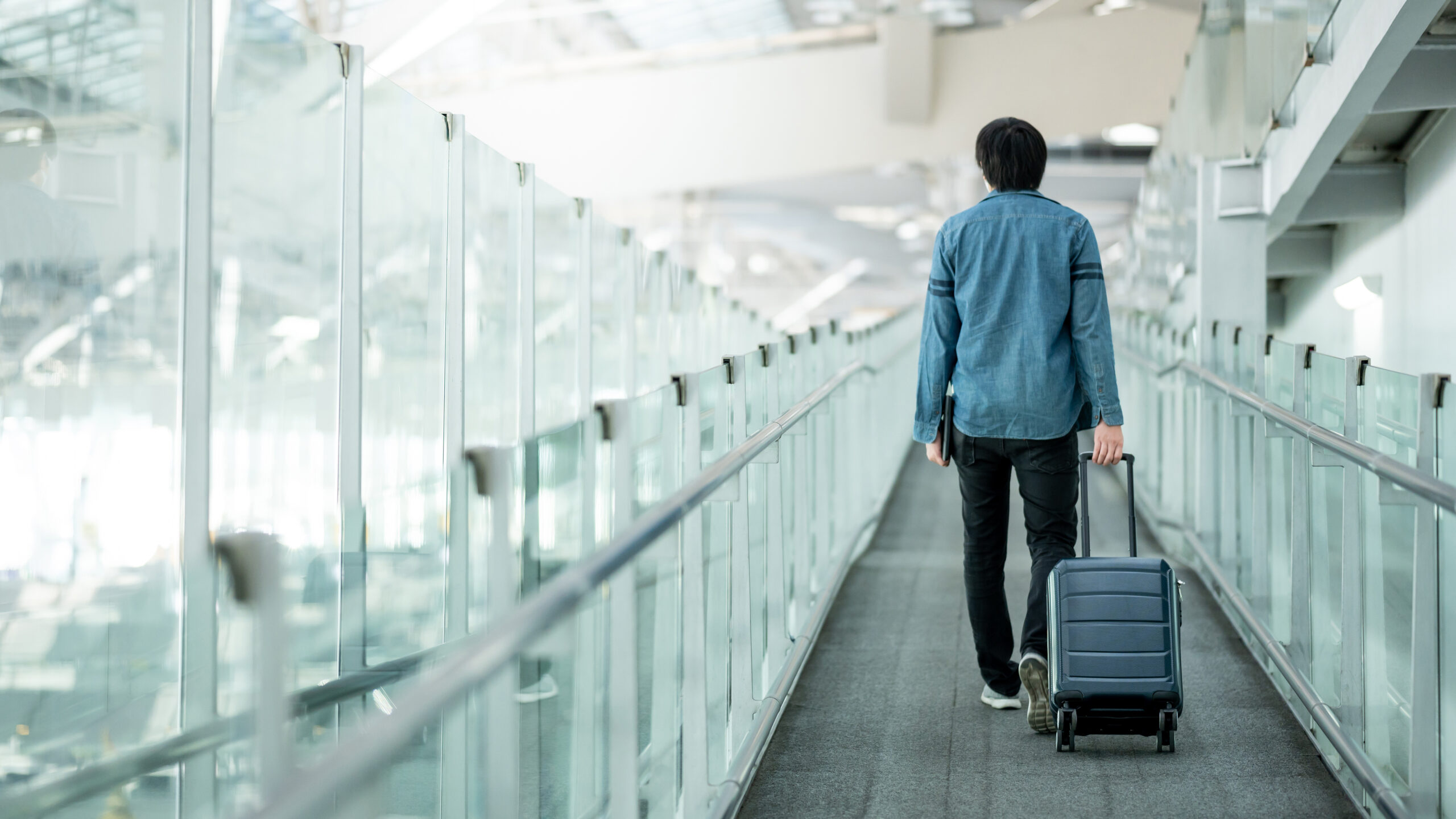 Asian man tourist walking in airport terminal