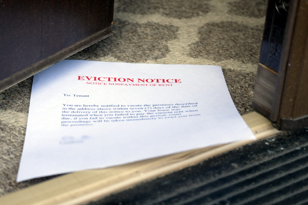 eviction notice on the floor slipped under opened entrance door