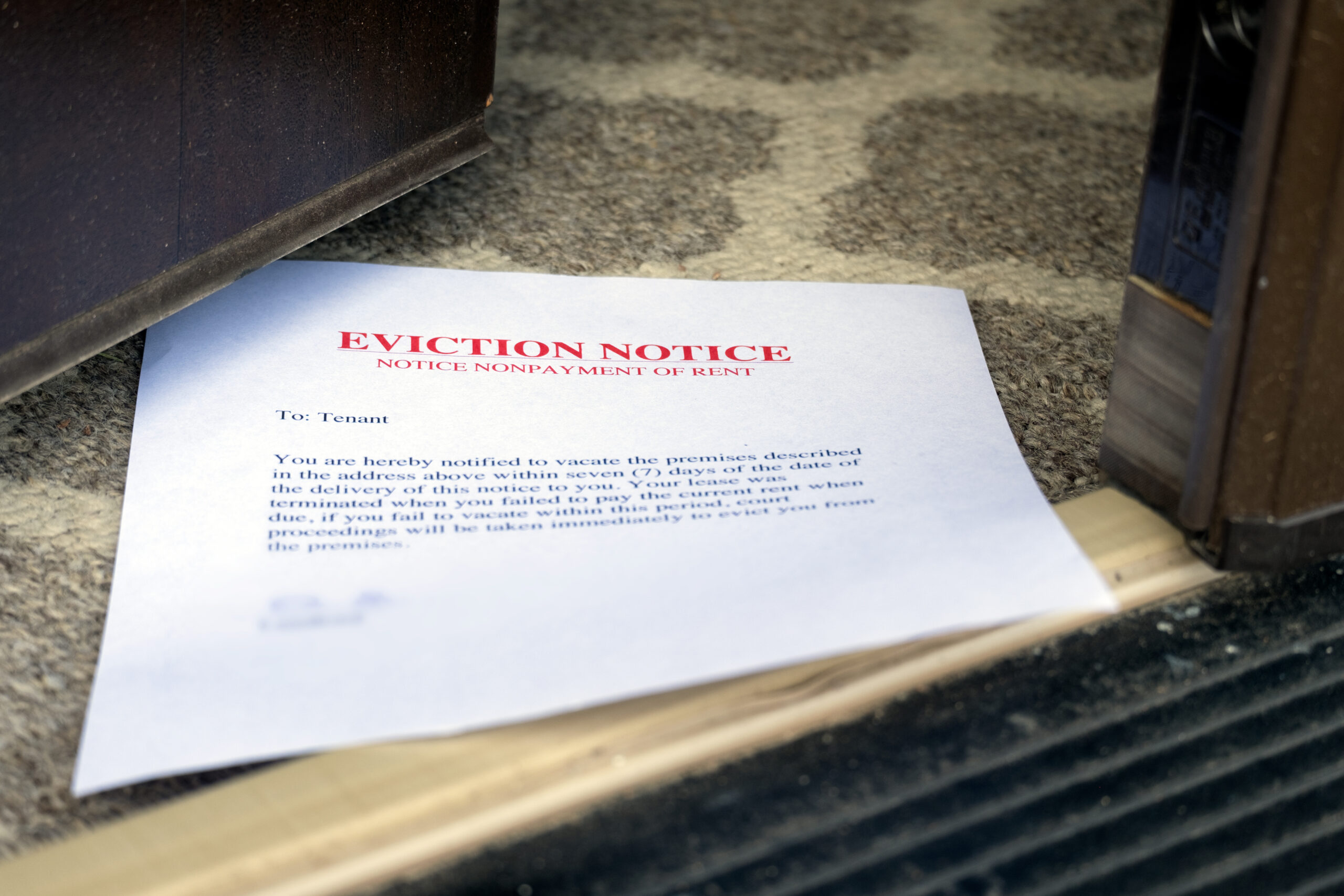 eviction notice on the floor slipped under opened entrance door - Lisa's Law Solicitors eviction notice on the floor slipped under opened entrance door