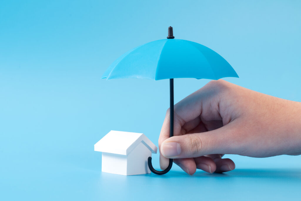 House model under blue umbrella