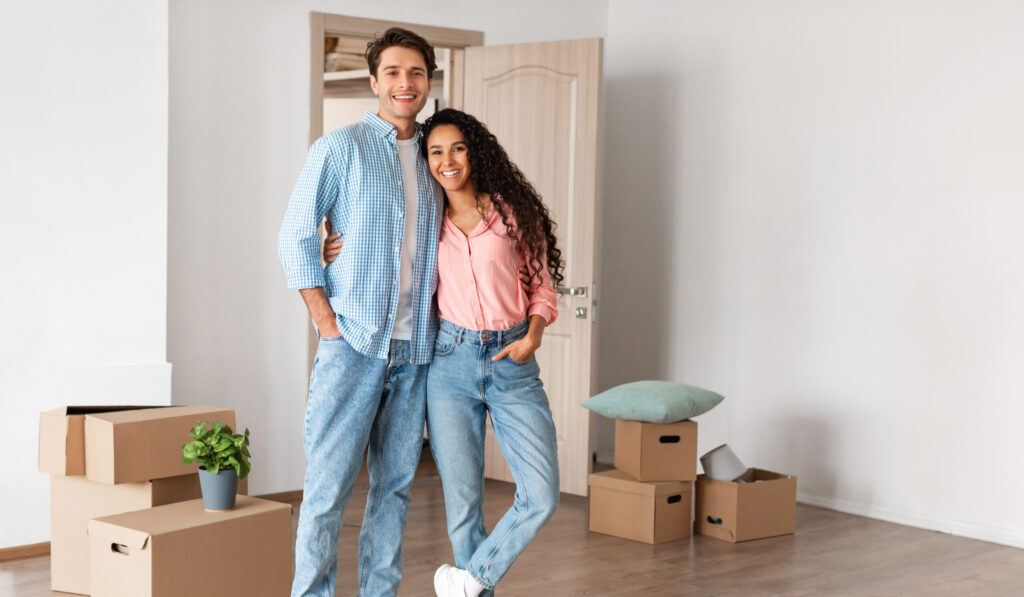Happy man and woman posing on moving day