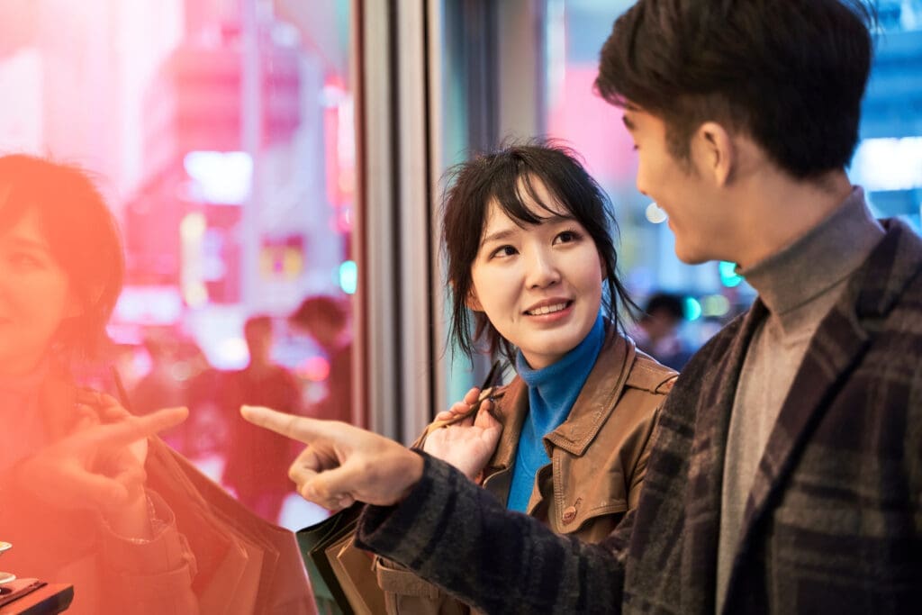 young asian couple shopping in modern city