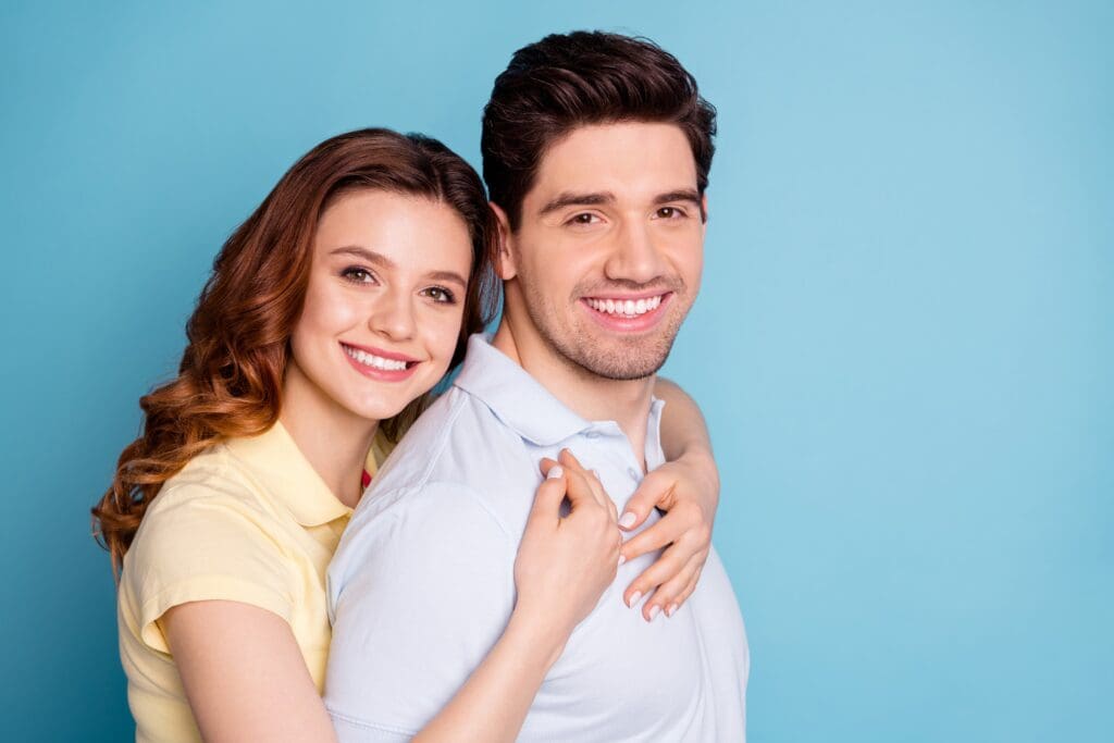 Close up side profile of smiling brunette couple