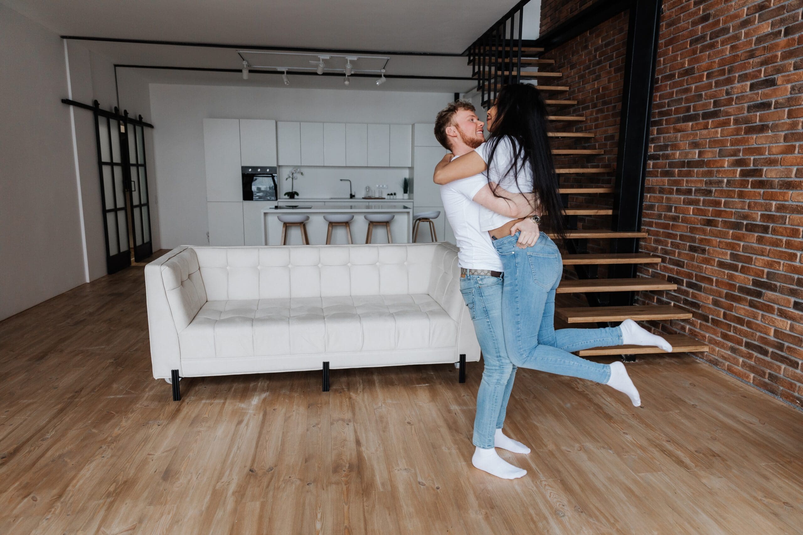 Happy multiracial couple first time home buyers celebrate moving day