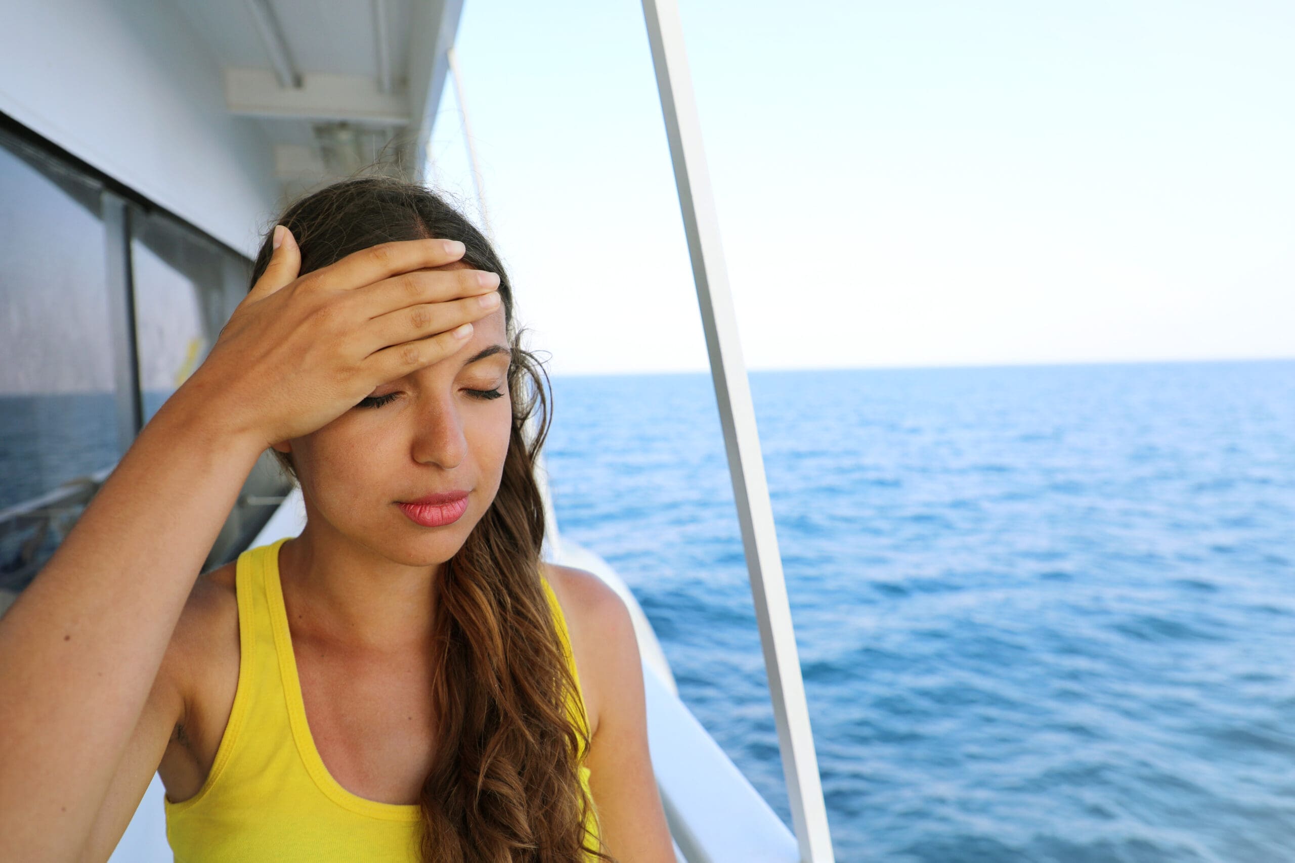 Young woman suffer from seasickness during vacation on boat Cruise sea motion sickness tourist woman on boat vacation with headache or nausea Fear of travel or illness virus on cruising holiday