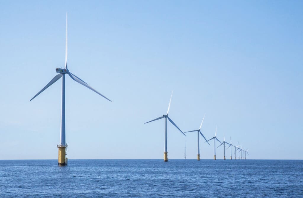 Wind turbines in an offshore wind farm in the North Sea just off the coast on a clear day.