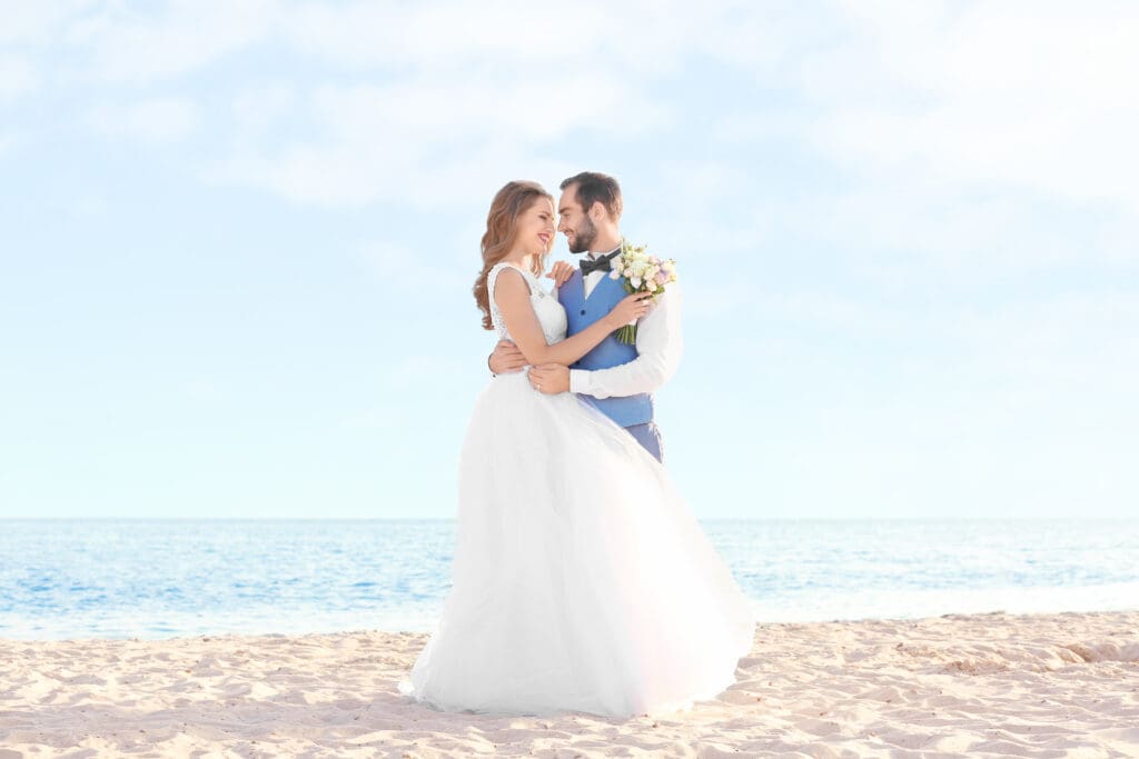 Happy wedding couple on sea beach