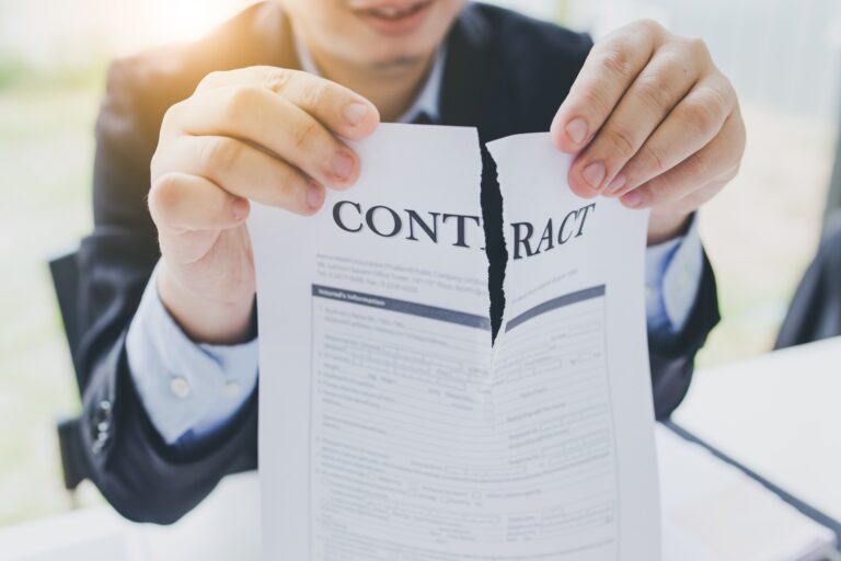 Contract being torn up by man in suit