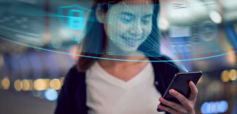 Face identification technology concept, Asian woman holding smartphone and scanning face ID recognition system.