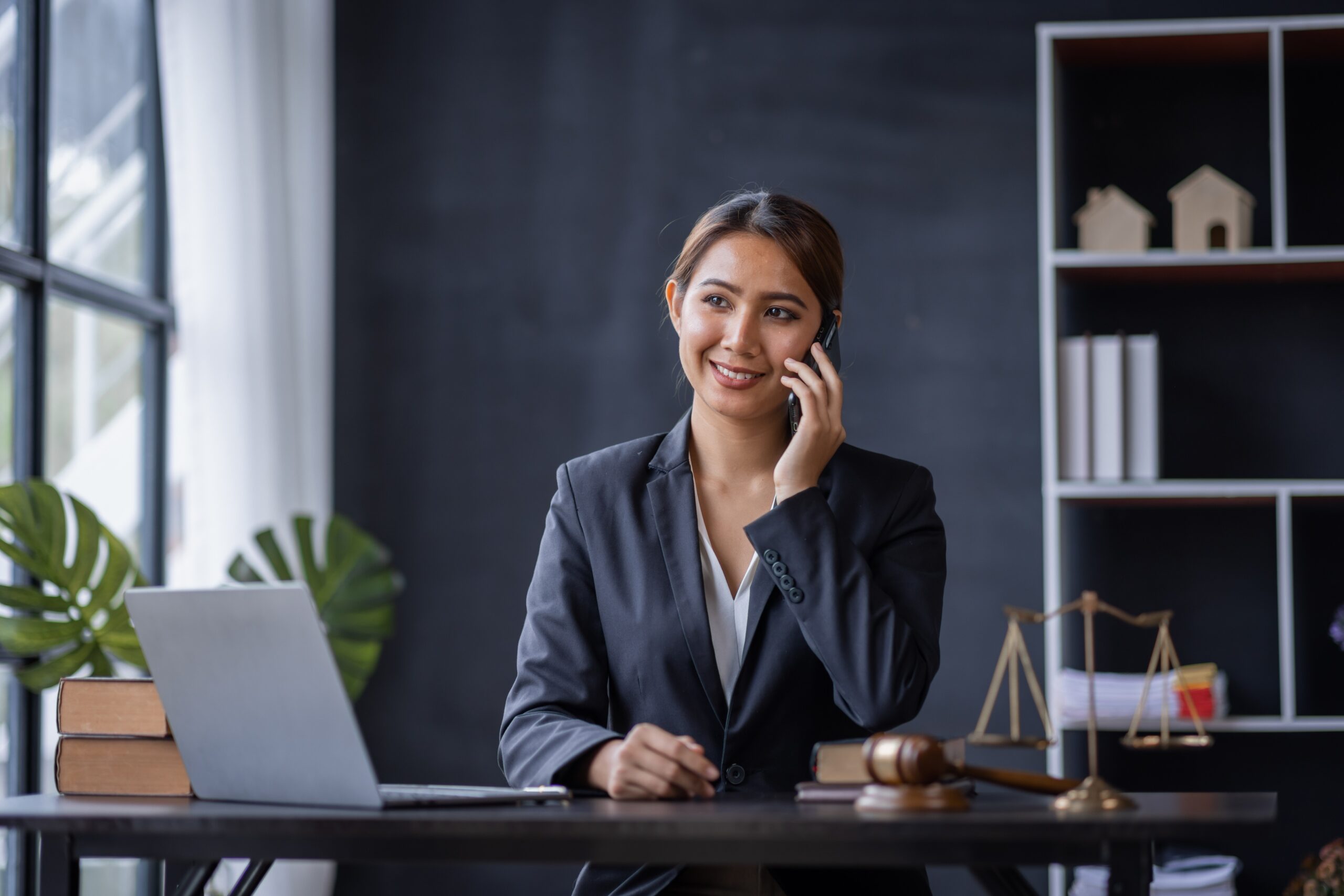 lawyer in office Business woman and lawyers discussing contract papers with brass scale on wooden desk
