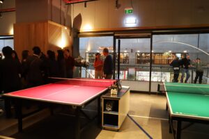 Table tennis tables with colleagues in the background